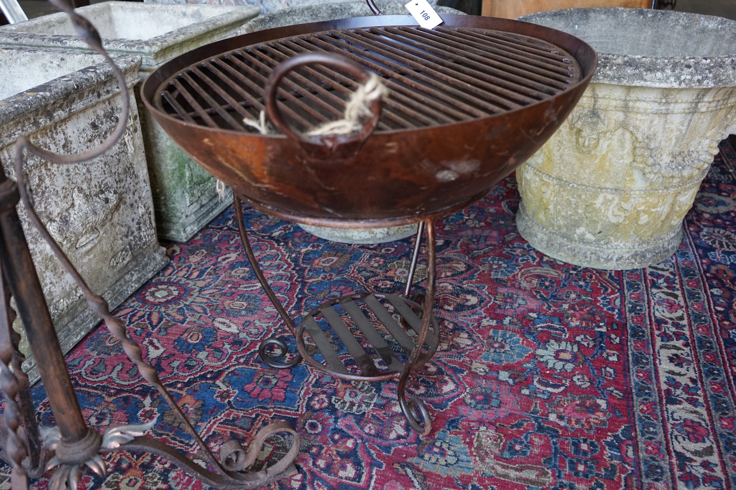A wrought and cast iron fire pit on stand, diameter 62cm, height 65cm